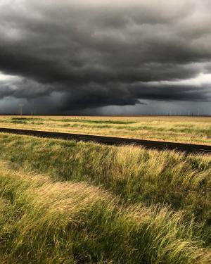 Oklahoma storms over a grassy field 